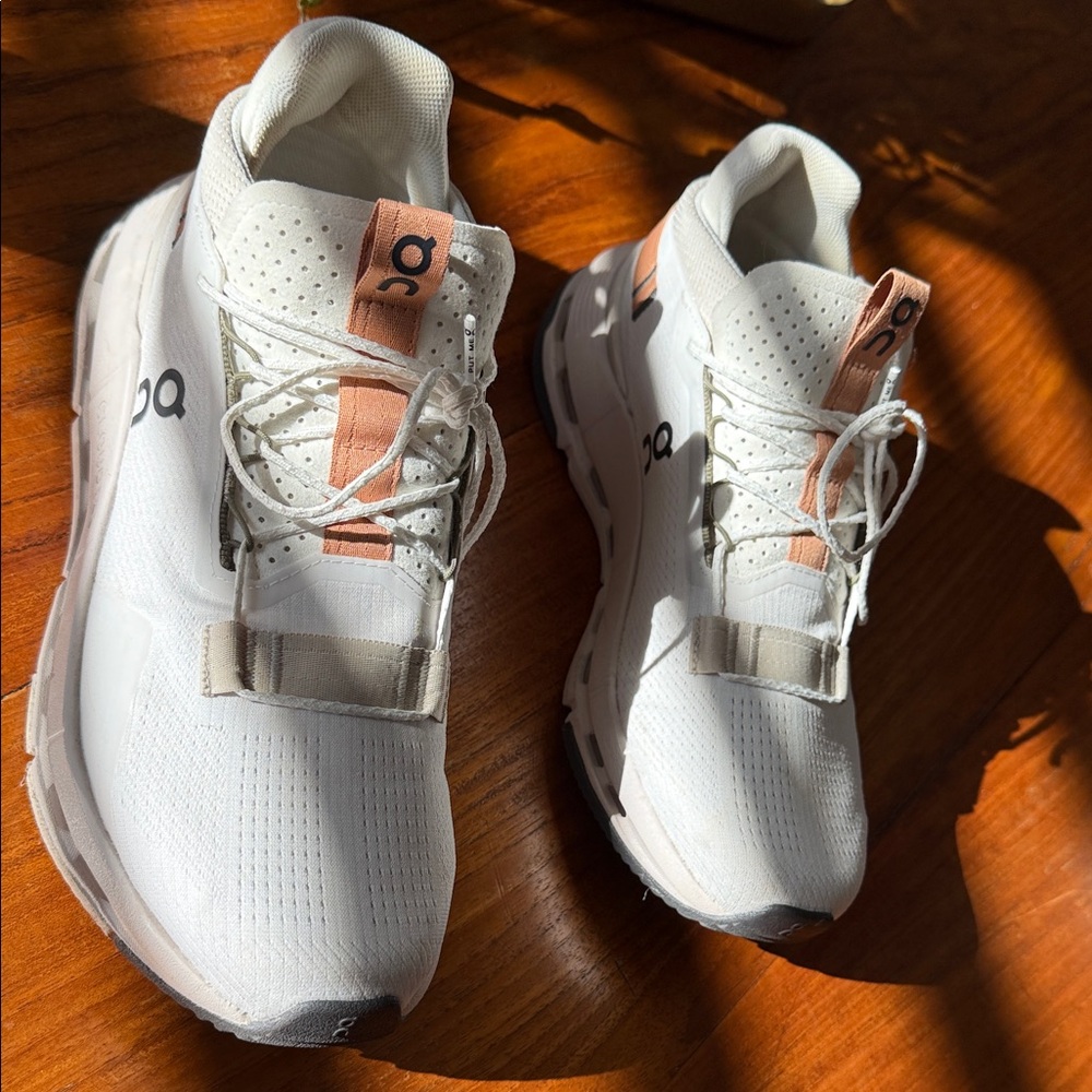 On Running White and Tan Athletic Shoes